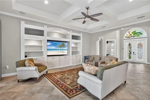 a large kitchen with kitchen island stainless steel appliances a stove a sink and a clock