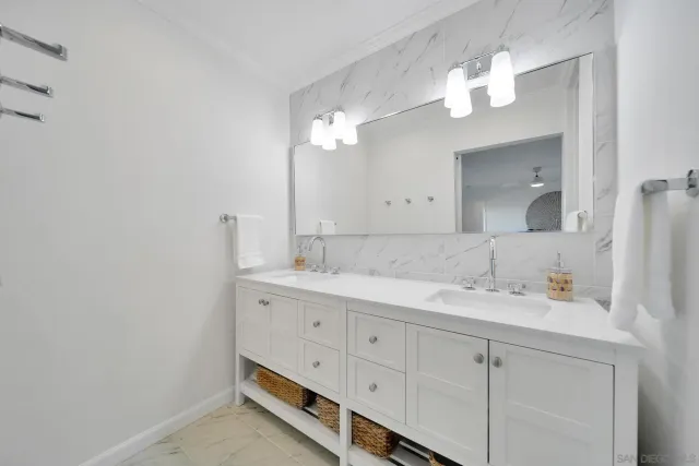 a bathroom with a double vanity sink and a mirror