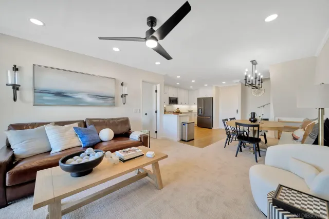 a living room with furniture and kitchen view