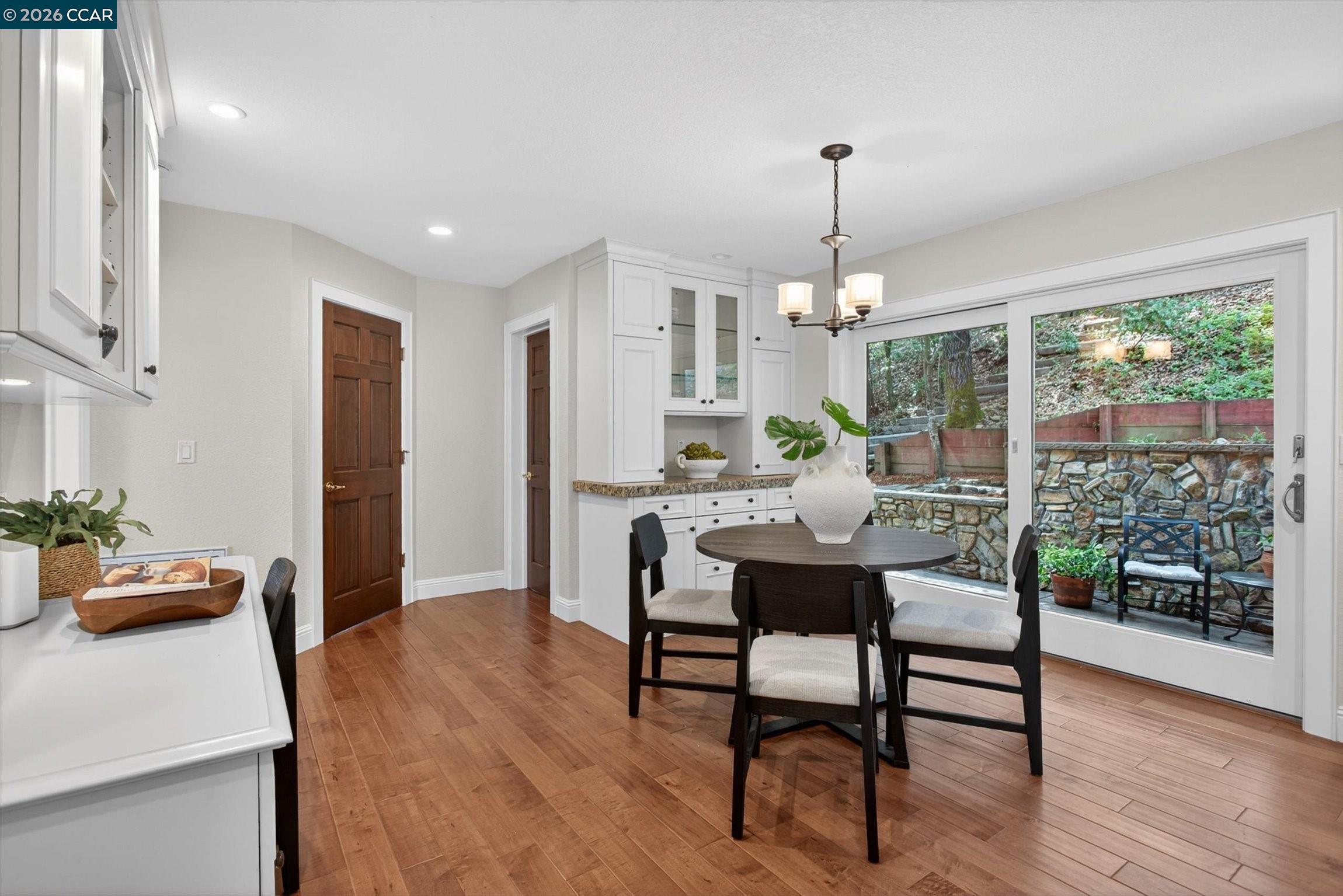 4105 Coralee Lane Lafayette, CA 94549 - Photo 17 of 43 a dining room with furniture a chandelier and wooden floor