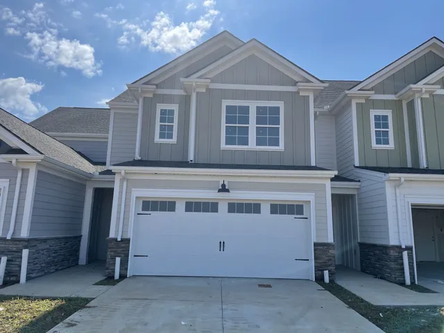 a front view of a house with a garage