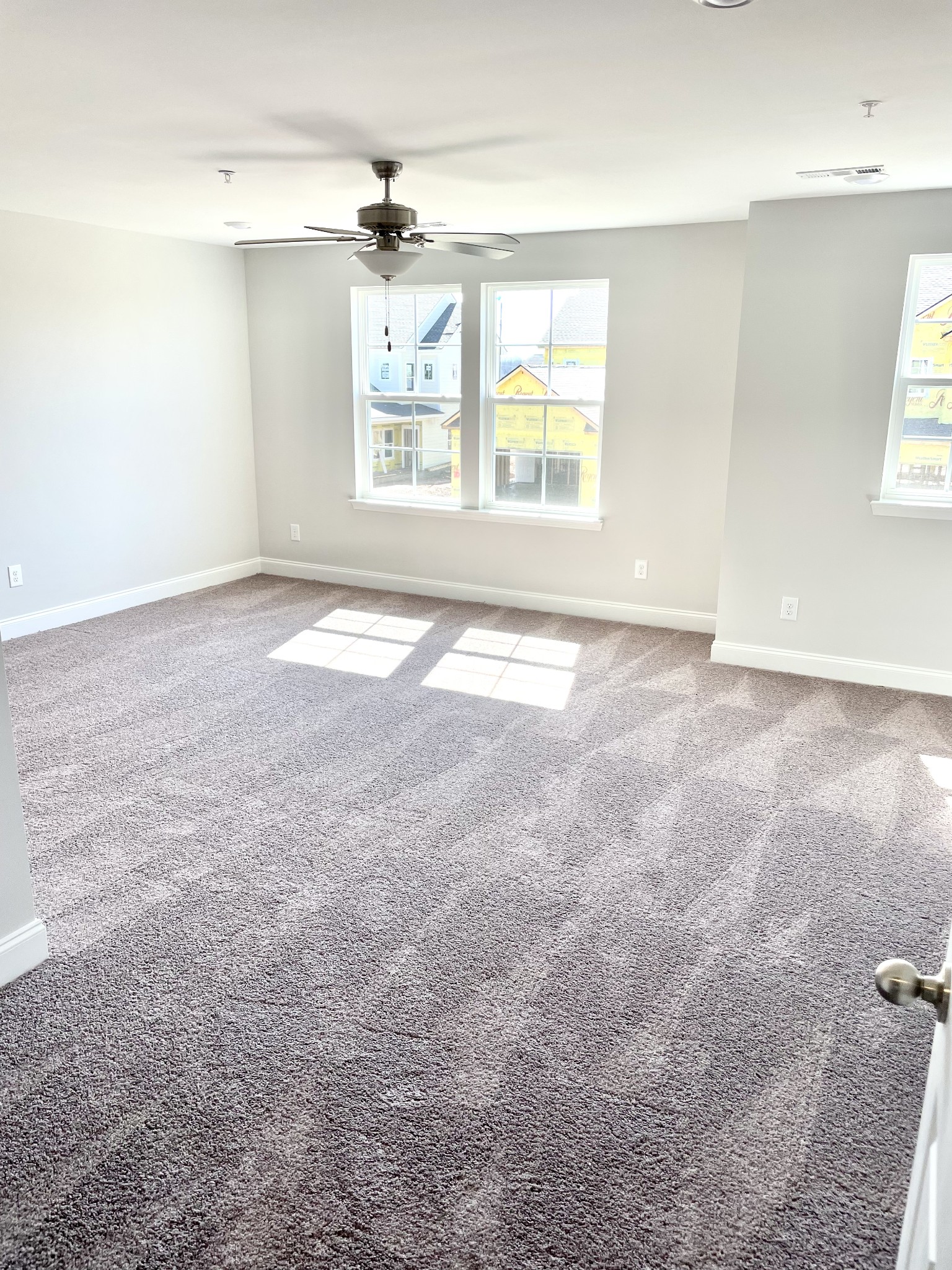 1004 June Wilde Ridge Spring Hill, TN 37174 - Photo 6 of 11 an empty room with windows and chandelier fan