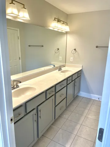 a bathroom with a sink vanity and mirror