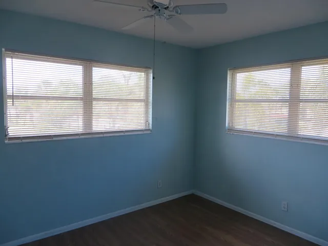 a view of an empty room with a ceiling fan