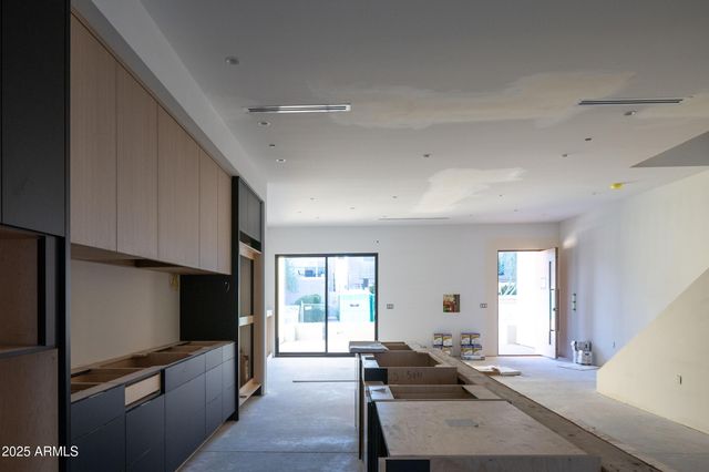 a kitchen with a sink and chairs