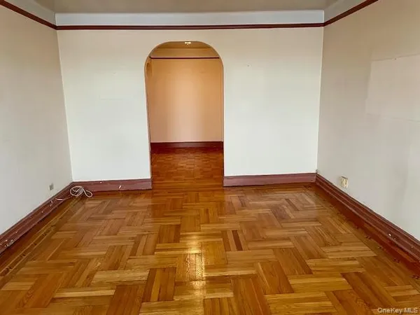 a view of a room with wooden floor and a shower