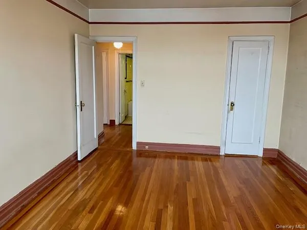 a view of a room with wooden floor and a ceiling fan
