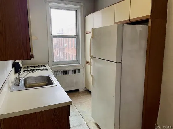 a white refrigerator freezer sitting inside of a kitchen