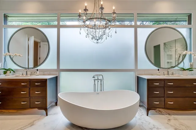 a bedroom with a bed wooden floor and a large window