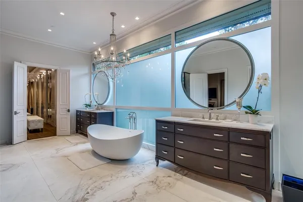 a spacious bathroom with a double vanity sink double mirror and bathtub