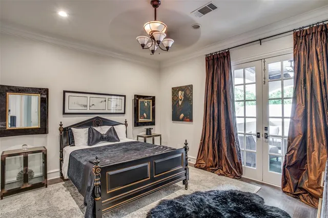 a large white kitchen with a stove a microwave oven a sink dishwasher and white cabinets with wooden floor