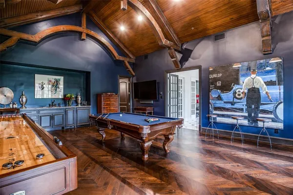 a living room with furniture pool table and a fireplace