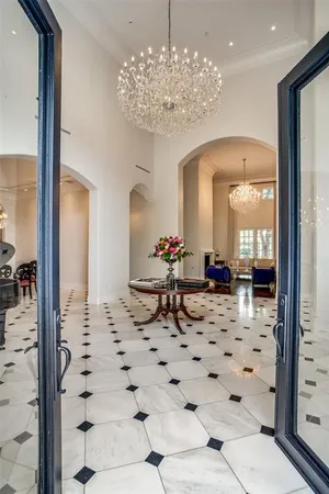 a lobby with a chandelier and living room