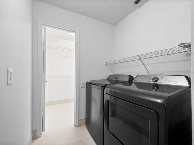 a view of storage and utility room with washer and dryer