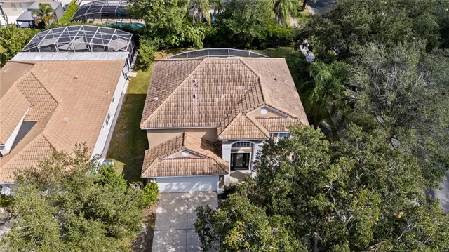 an aerial view of residential houses with outdoor space and lake view