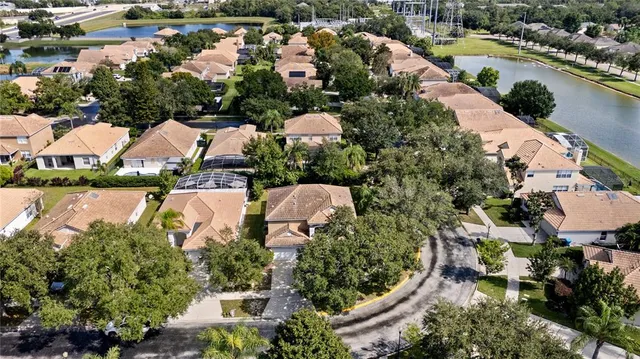 an aerial view of a house with a yard and lawn chairs