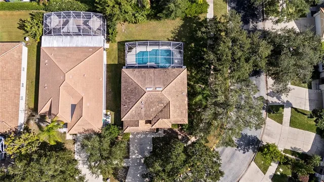 an aerial view of a houses with swimming pool