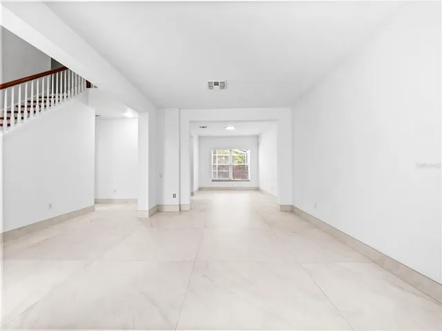 an empty room with a empty space and windows