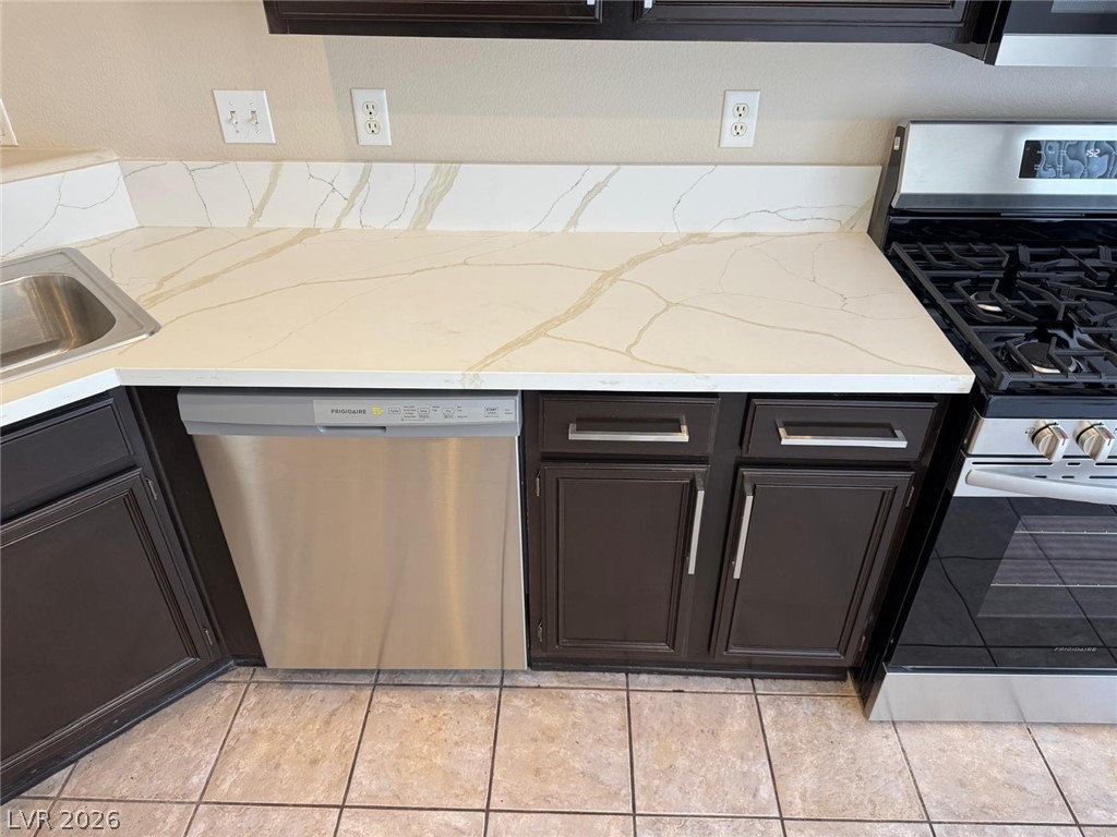 3962 Coyote Ridge Court Las Vegas, NV 89129 - Photo 7 of 35 Stainless steel appliances and rich cabinetry define this culinary workspace.