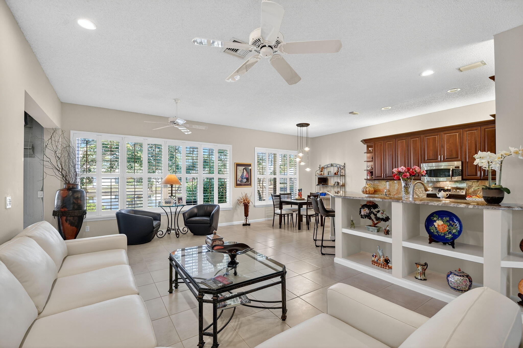 7811 Rockford Road Boynton Beach, FL 33472 - Photo 13 of 72 a living room with furniture a window and a view of kitchen