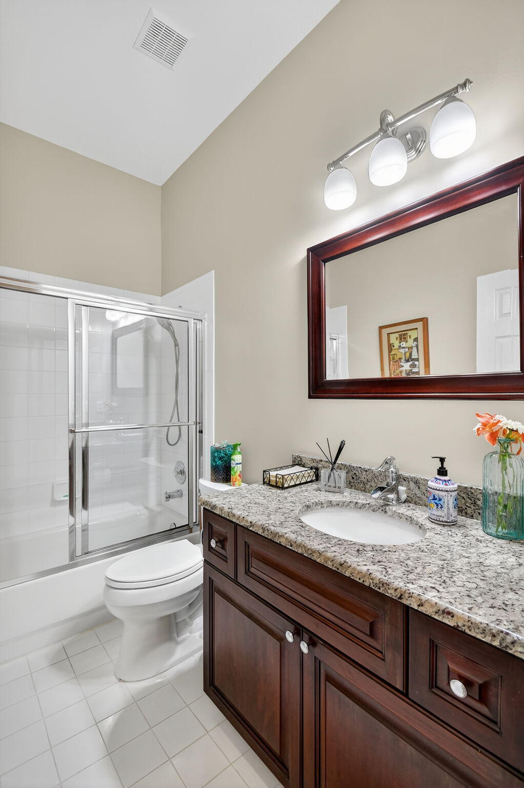 7811 Rockford Road Boynton Beach, FL 33472 - Photo 25 of 72 a bathroom with a granite countertop sink a toilet a mirror and shower