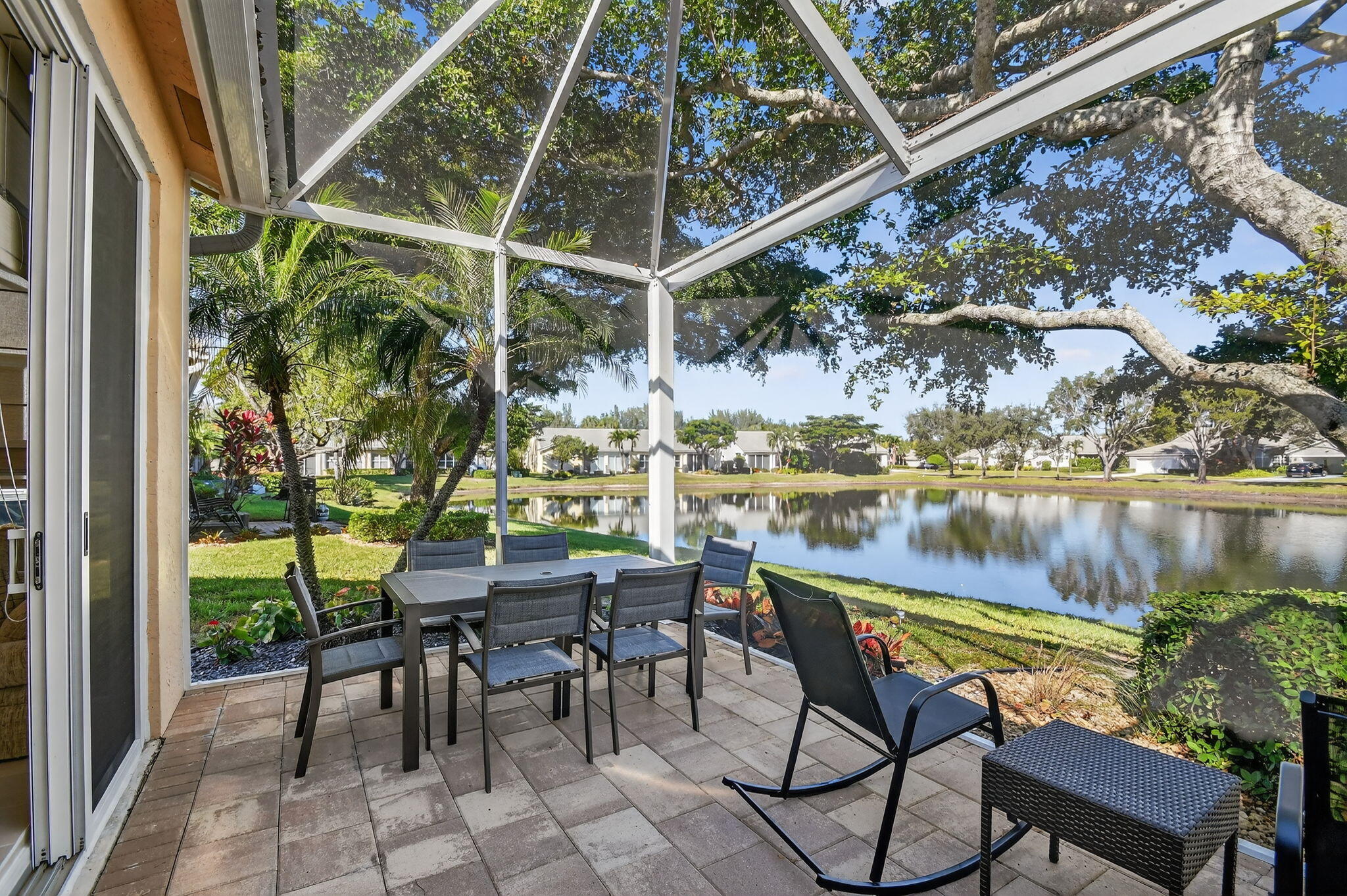 7811 Rockford Road Boynton Beach, FL 33472 - Photo 28 of 72 a view of a chairs and table in patio with a lake view