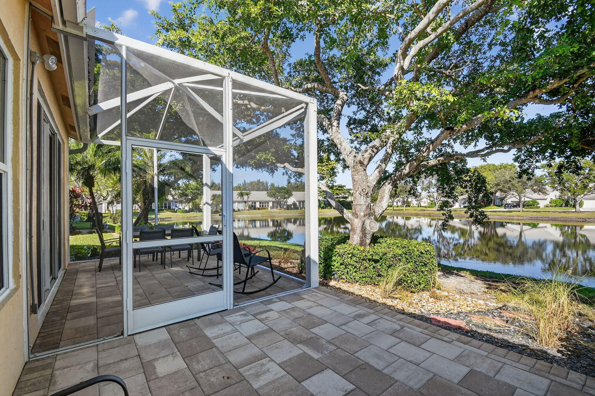 7811 Rockford Road Boynton Beach, FL 33472 - Photo 32 of 72 a view of patio with table and chairs under an umbrella