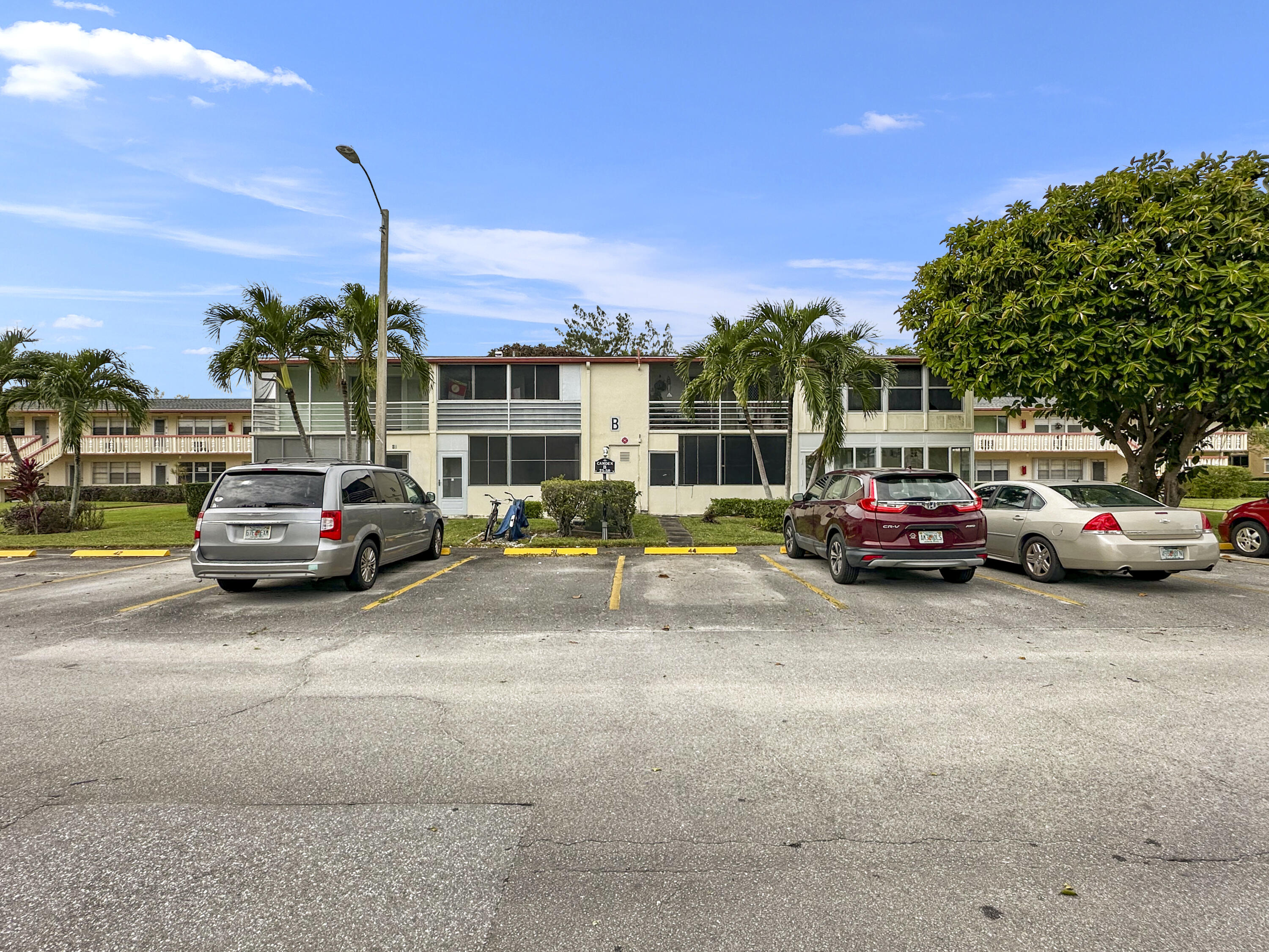 47 Camden B West Palm Beach, FL 33417 - Photo 3 of 36 a view of a cars parked in front of a house