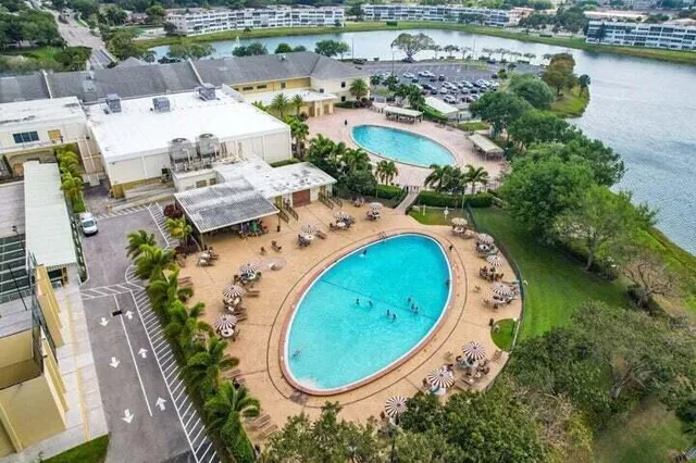 an aerial view of a swimming pool with outdoor space and lake view