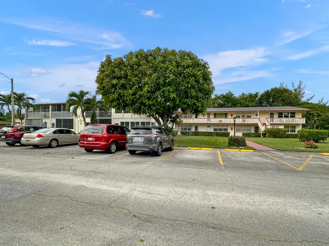 a view of a cars park on the side of a street