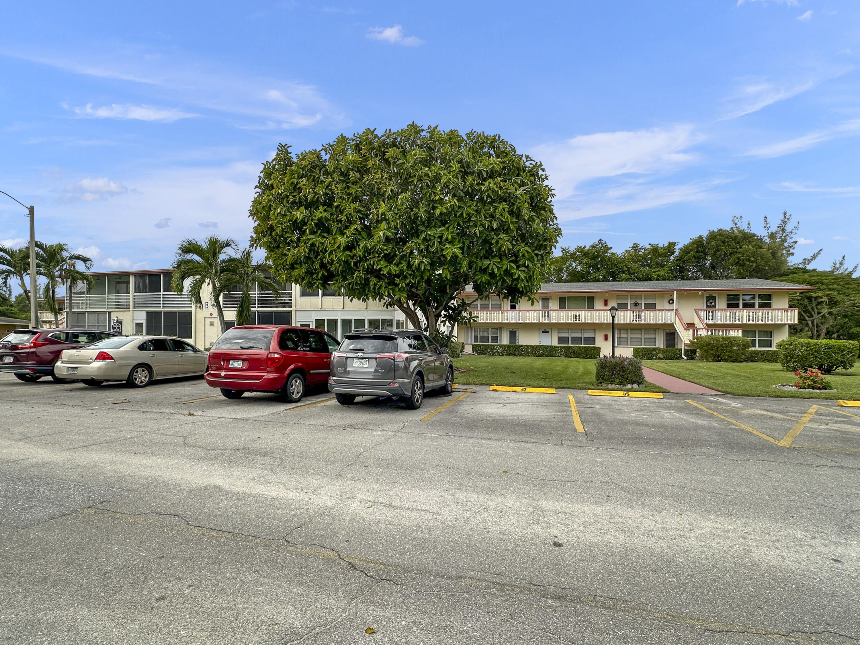 47 Camden B West Palm Beach, FL 33417 - Photo 34 of 36 a view of a cars park on the side of a street