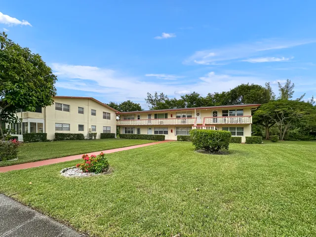 a front view of a house with a yard table and chairs