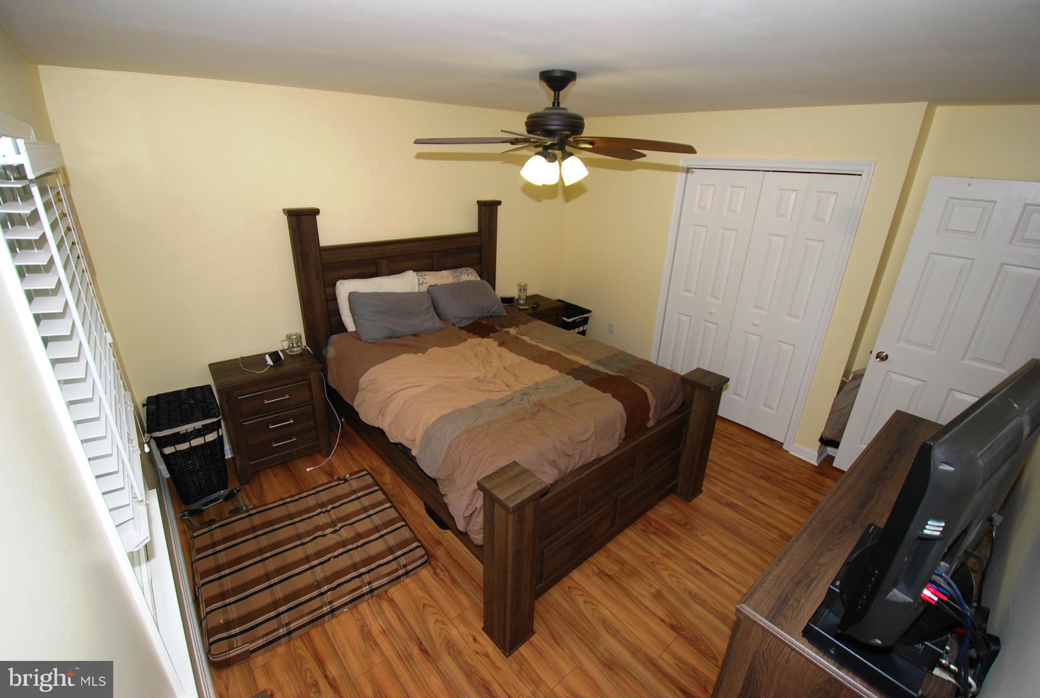 12351 Weller Road Monrovia, MD 21770 - Photo 14 of 24 a bedroom with a bed and a flat tv screen on a dresser