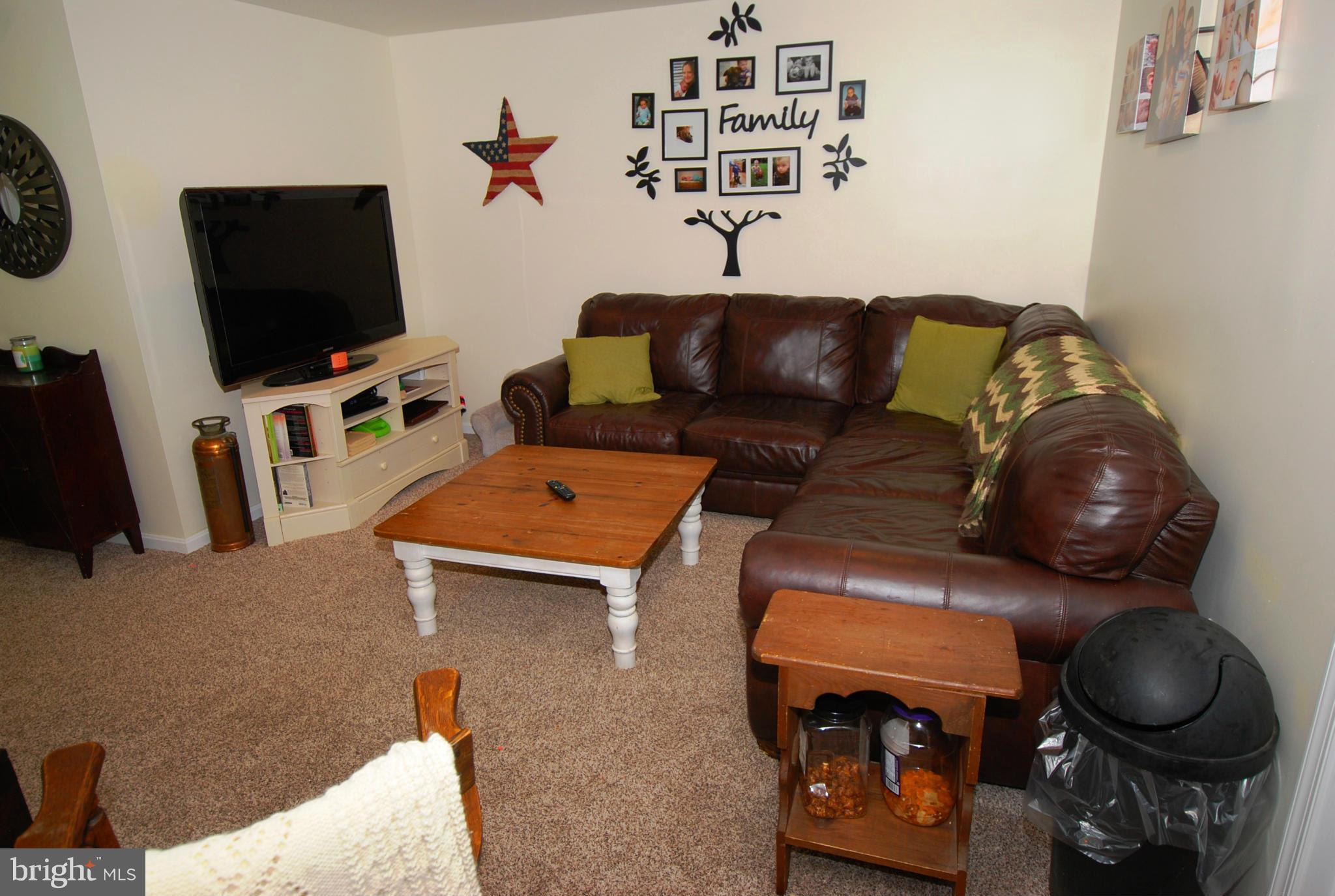 12351 Weller Road Monrovia, MD 21770 - Photo 22 of 24 a living room with furniture and a flat screen tv