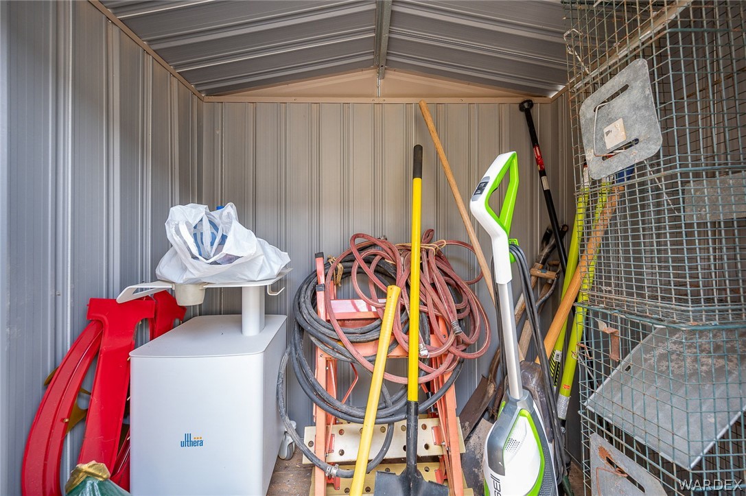 2465 Egar Road Golden Valley, AZ 86413 - Photo 55 of 98 The property includes a utilitarian shed with corrugated metal walls and roof, providing additional storage space
