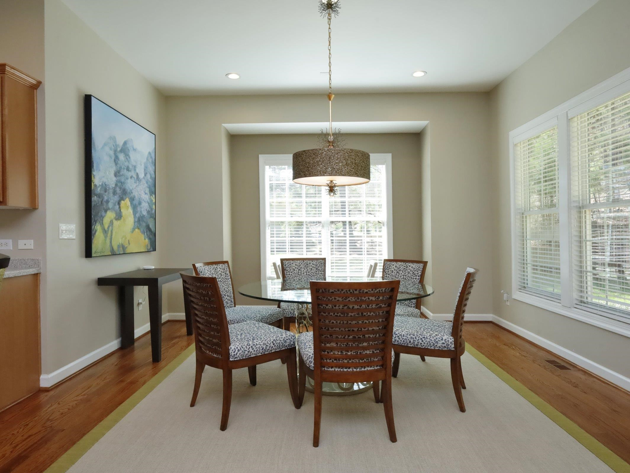 2565 Bittersweet Drive Durham, NC 27705 - Photo 15 of 37 a dining room with furniture a chandelier and wooden floor
