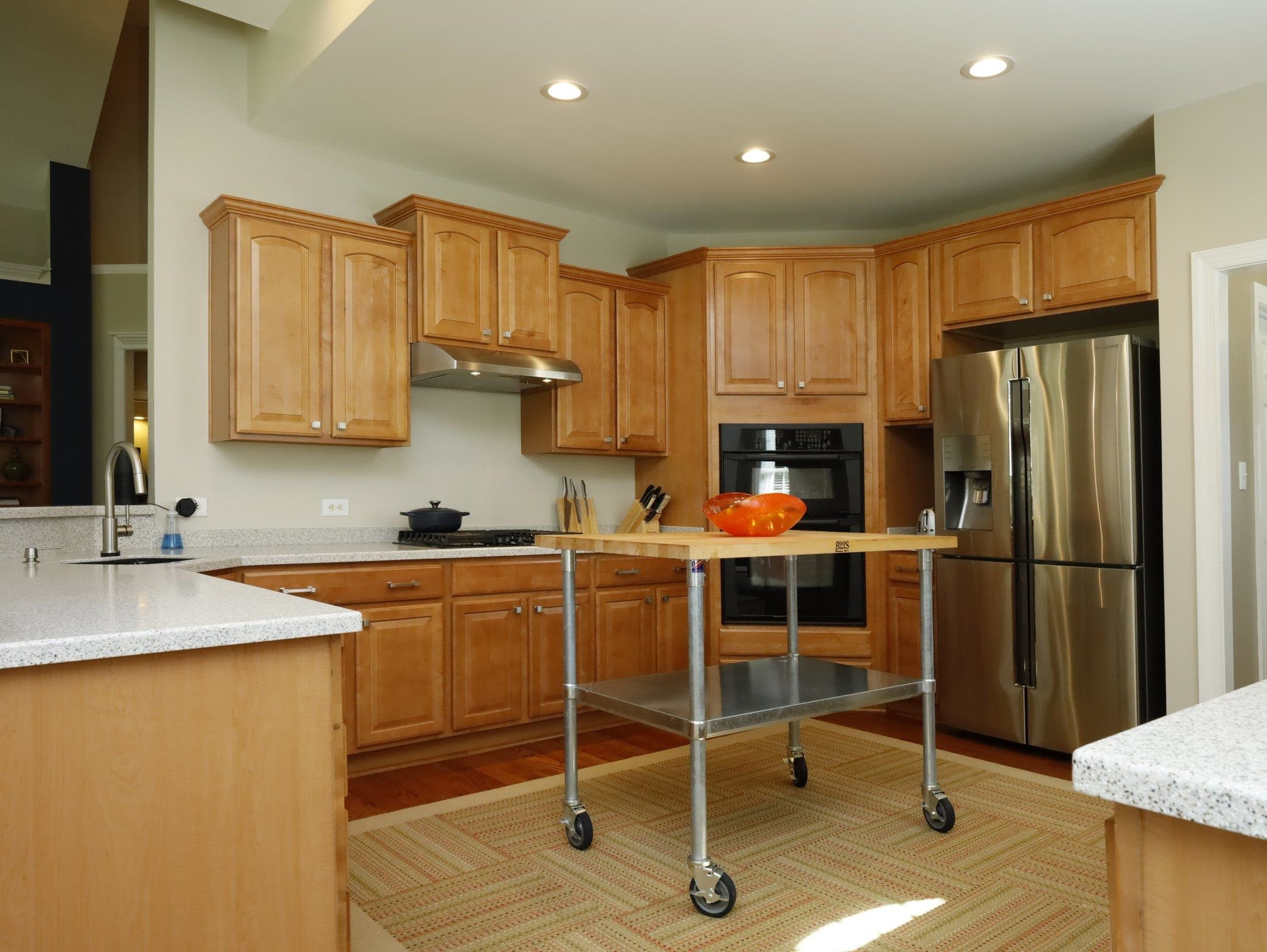 2565 Bittersweet Drive Durham, NC 27705 - Photo 18 of 37 a kitchen with stainless steel appliances granite countertop a refrigerator and wooden cabinets