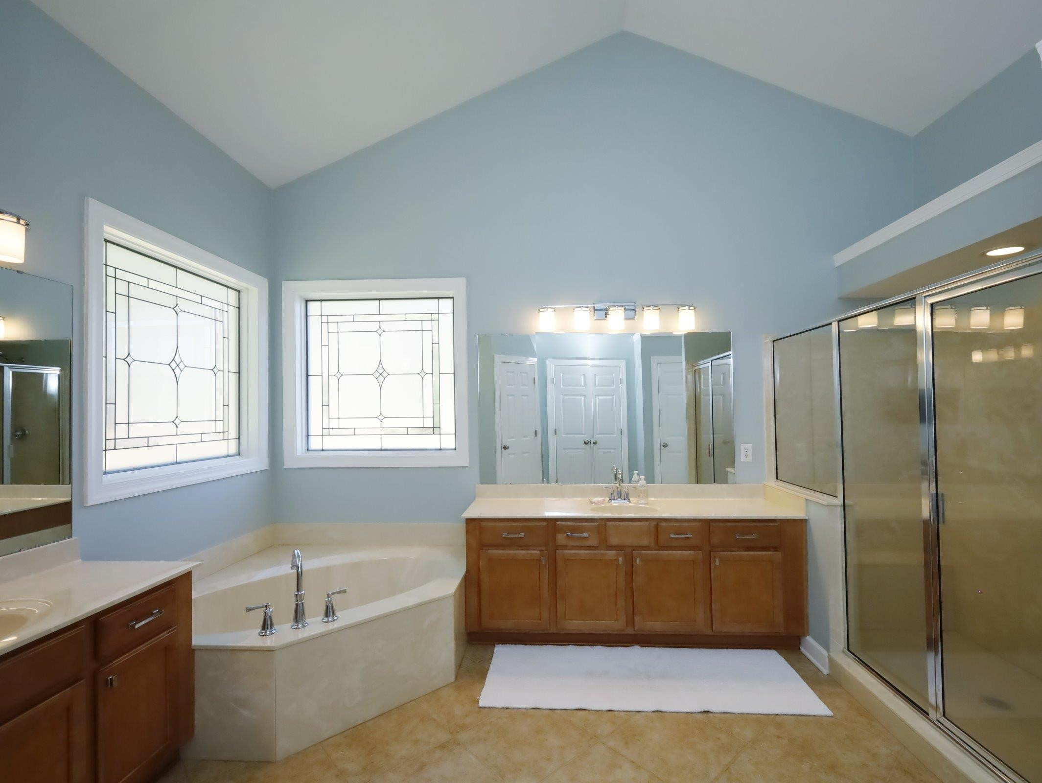 2565 Bittersweet Drive Durham, NC 27705 - Photo 25 of 37 a bathroom with a tub a sink and a large mirror