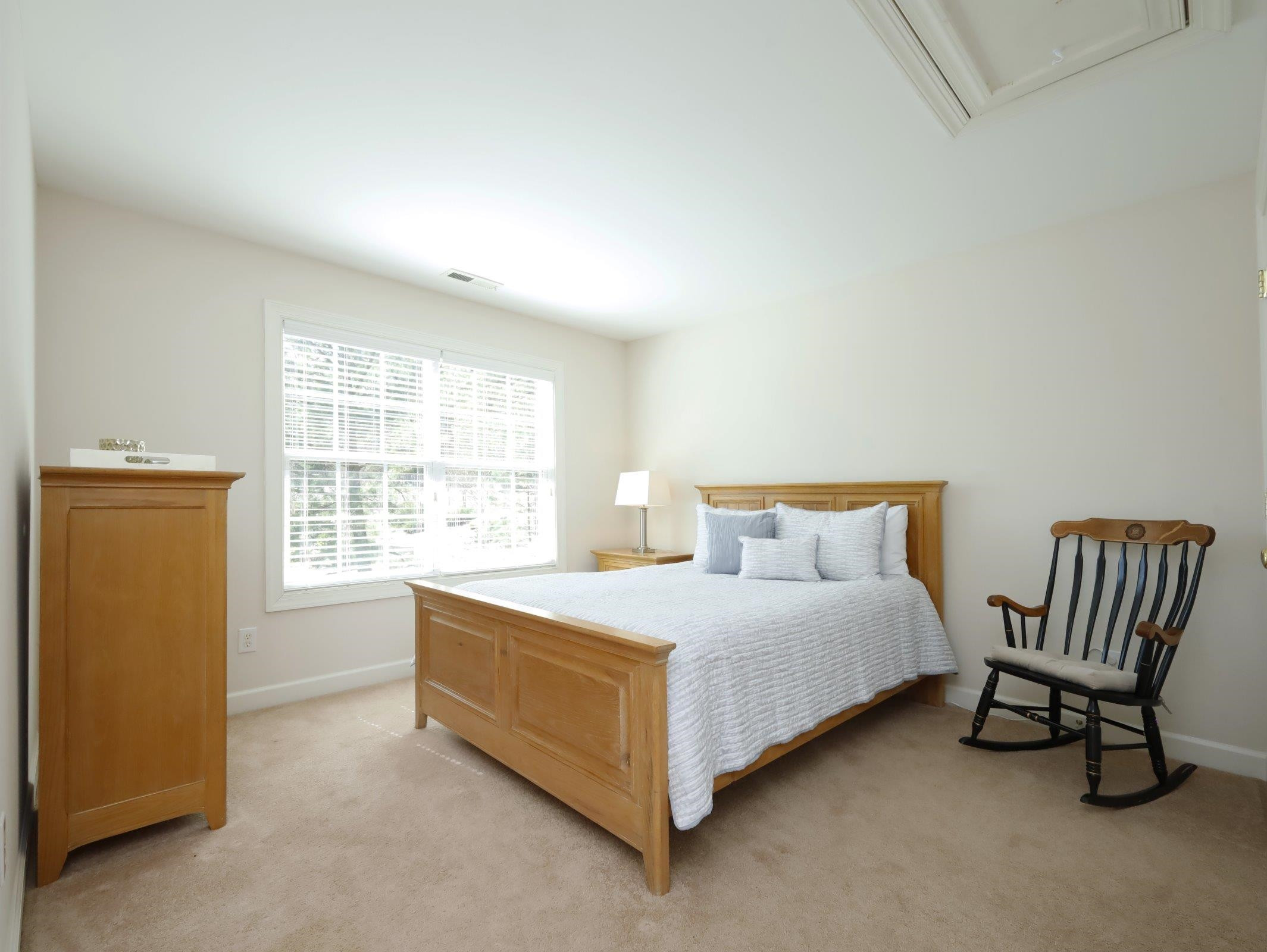 2565 Bittersweet Drive Durham, NC 27705 - Photo 30 of 37 a bedroom with a bed and a chair