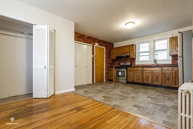 a view of a kitchen with a stove cabinets and a wooden floor