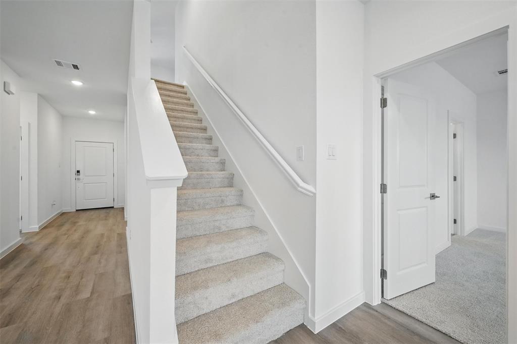 1413 Richardson Street Howe, TX 75459 - Photo 18 of 30 Modern staircase with carpeted treads and a painted handrail