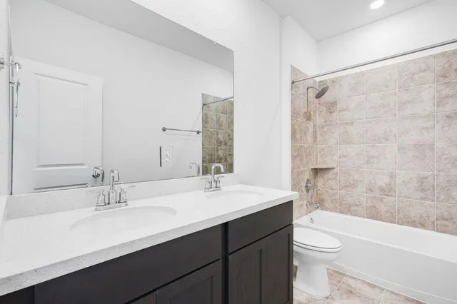 a bathroom with a sink double vanity and a mirror