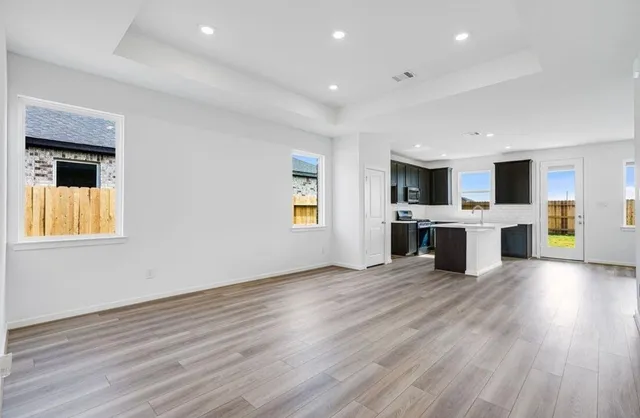 a view of kitchen with microwave and stove top oven