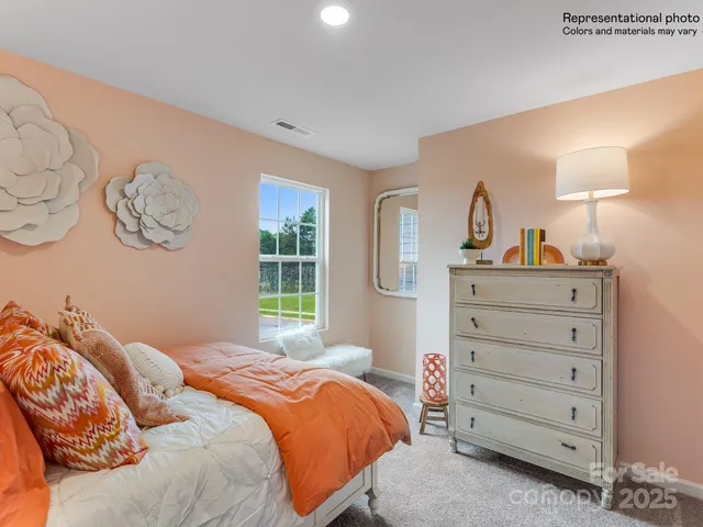 a bedroom with a bed and a refrigerator