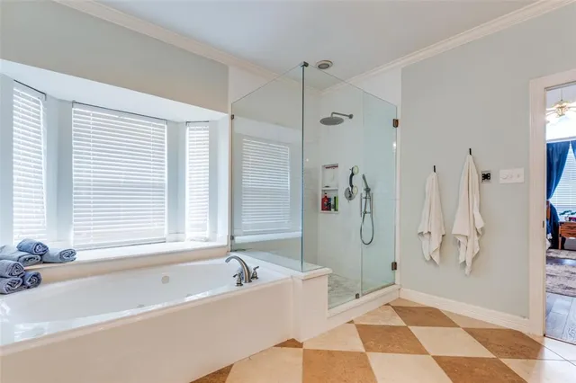 a spacious bathroom with a tub shower and a sink