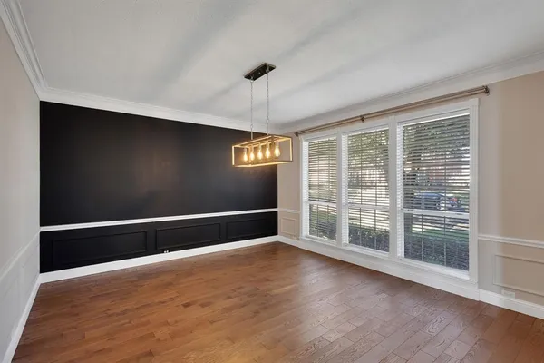 a view of wooden floor and windows in a room