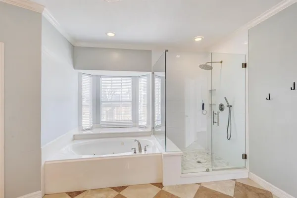 a bath room with a bath tub and a shower