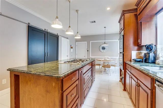 a kitchen with stainless steel appliances granite countertop a stove and a sink
