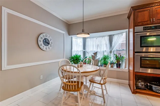 a dining room with furniture and a window