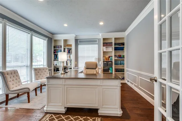 a living room with furniture a wooden floor and a large window